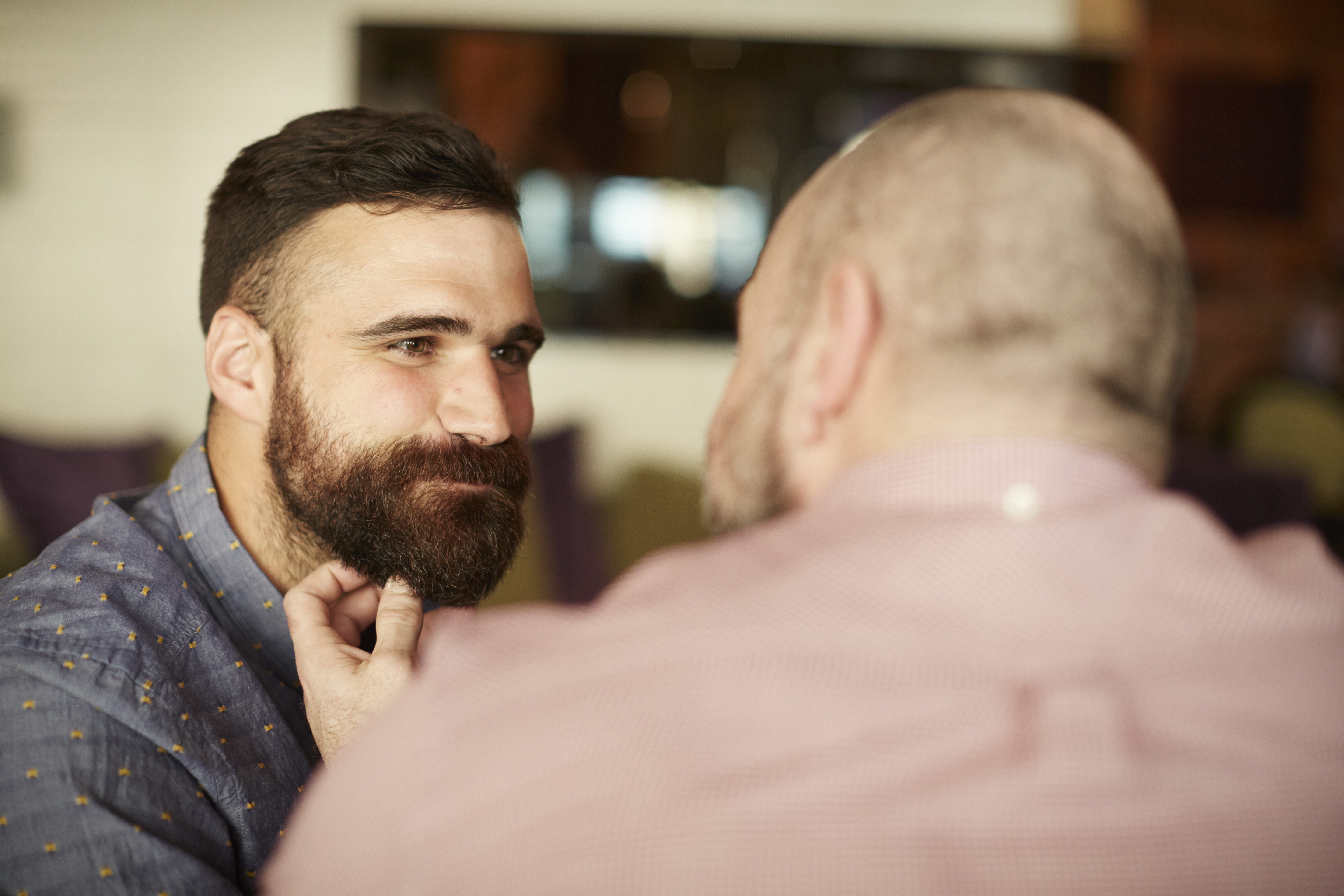 Closeup of two gay men being affectionate