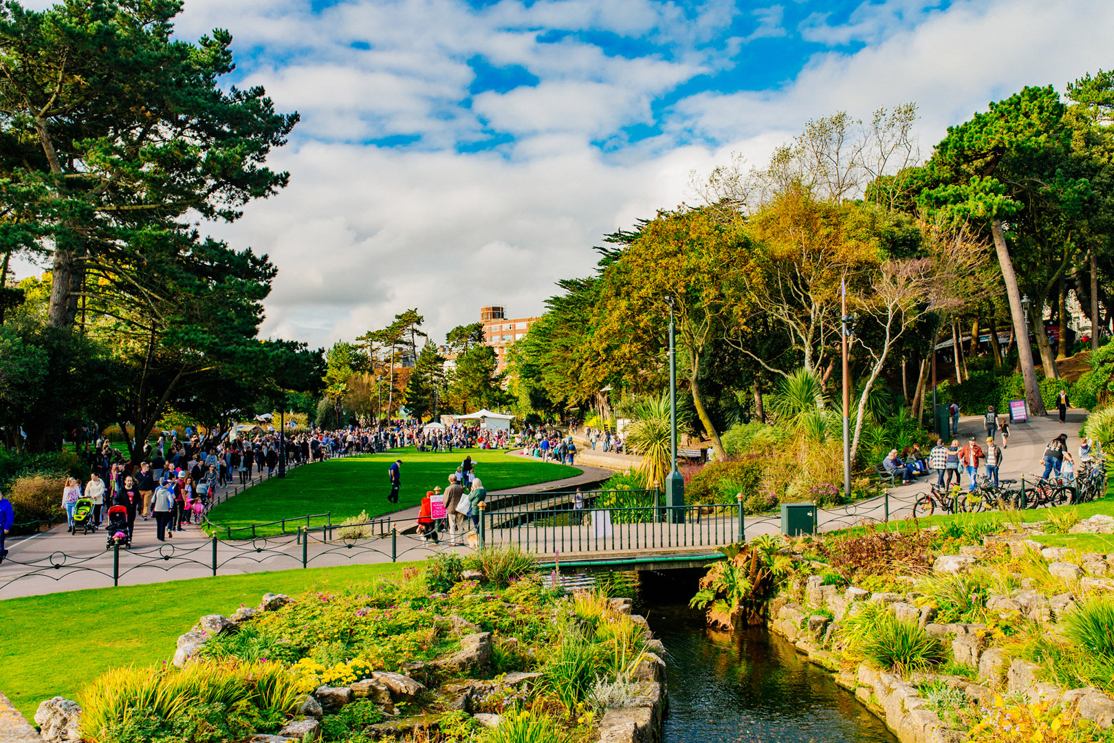People walking in a park on a sunny day.