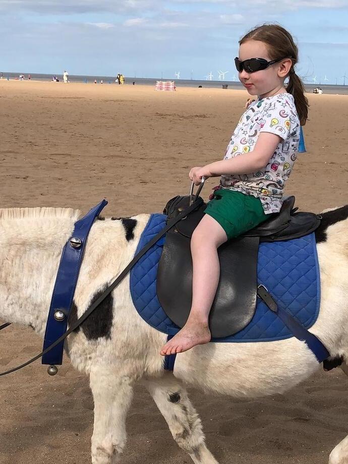 A child riding a donkey on Skegness Beach