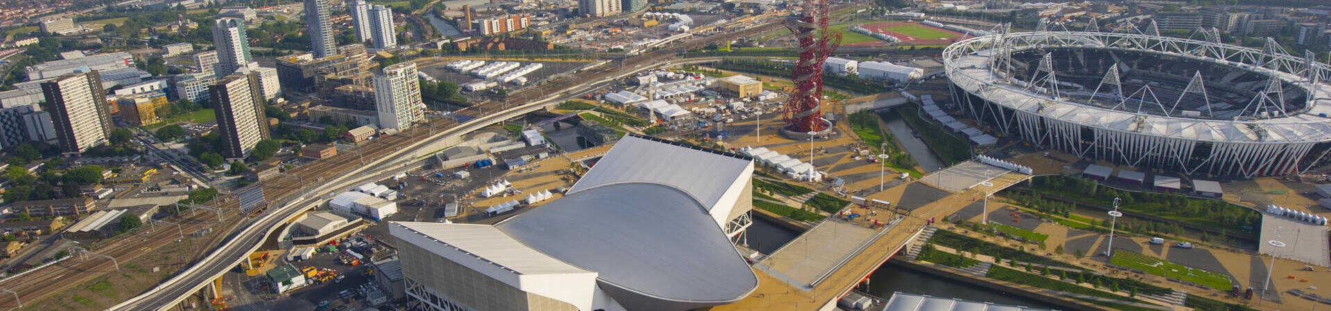 Aerial view of a city with stadium and modern buildings