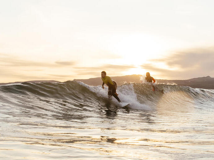 Hombre y mujer haciendo surf en el mar