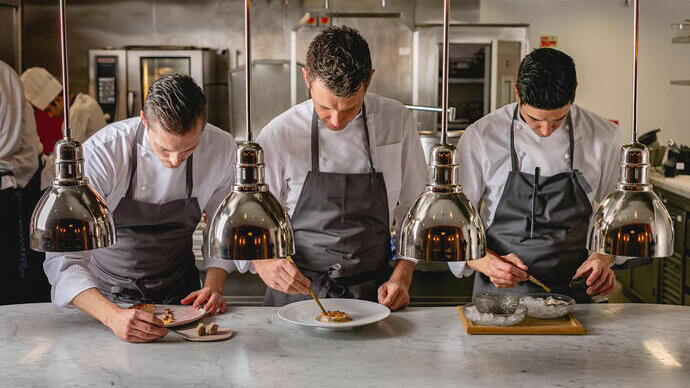 Chefs preparing food at counter, The Connaught