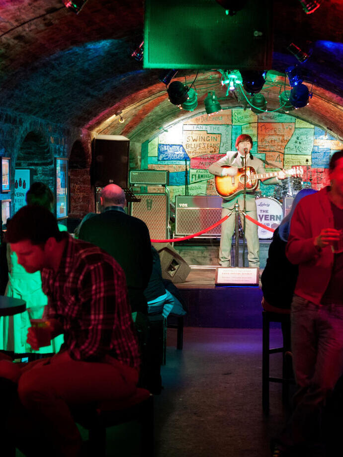 Inside club showing arched ceilings, coloured lights and stage, Liverpool