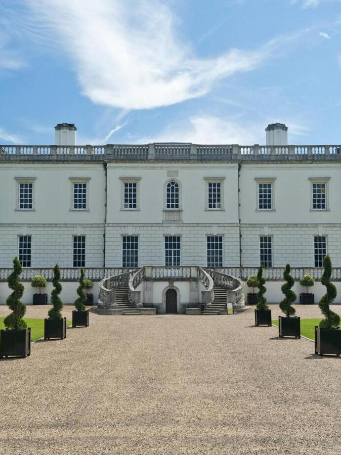 The northern facade and pristin gardens of a stately mansion.