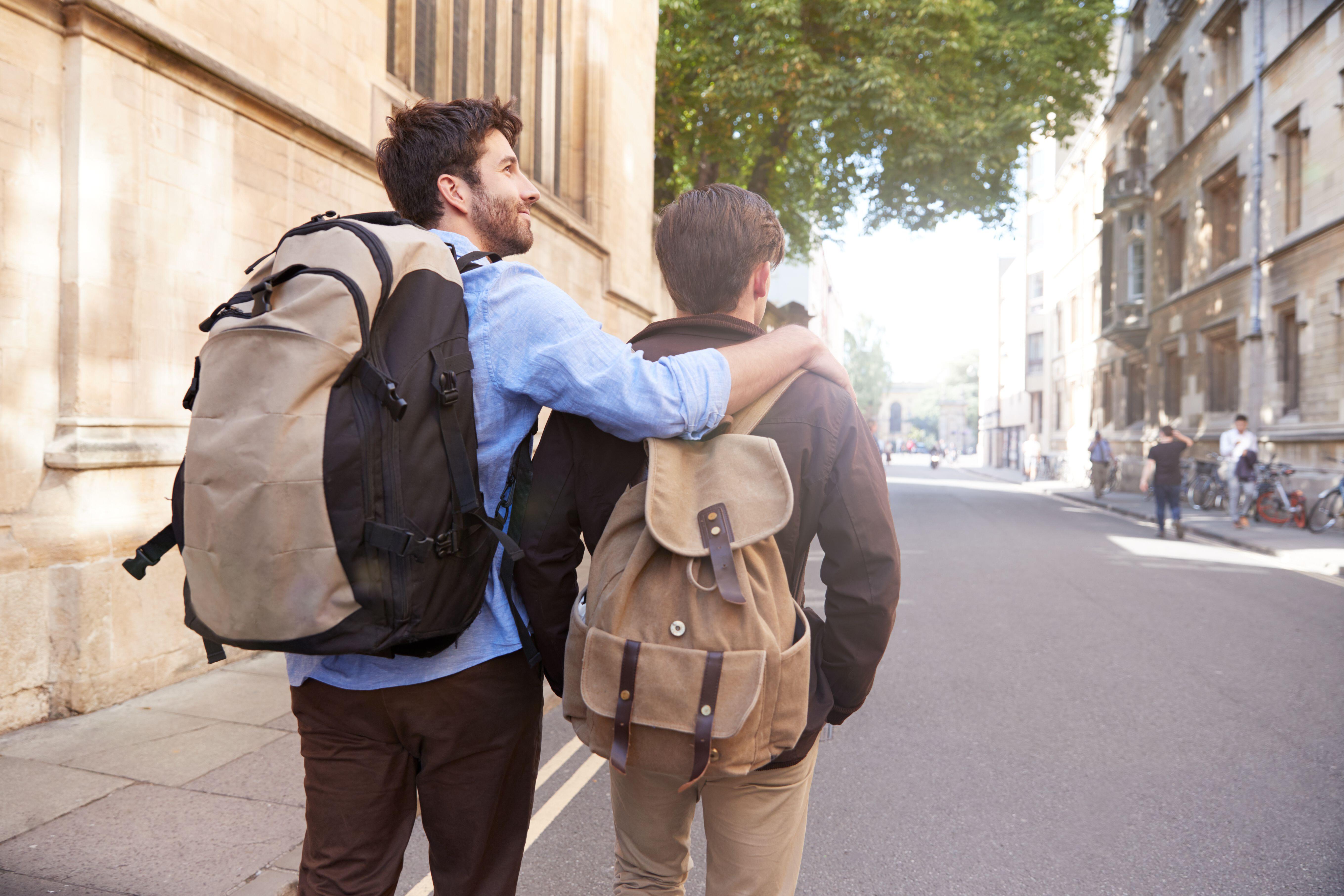 Gay couple walking together along a city street