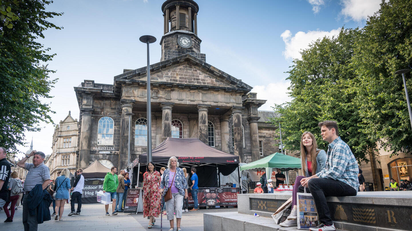 Groups of people exploring the city centre of Lancaster