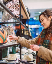 A woman shopping for accessories in boutique.