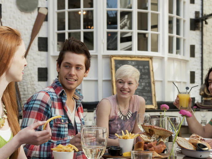 A group of people in a restaurant in Brighton, eating in the open air at Fishy Fishy restaurant.