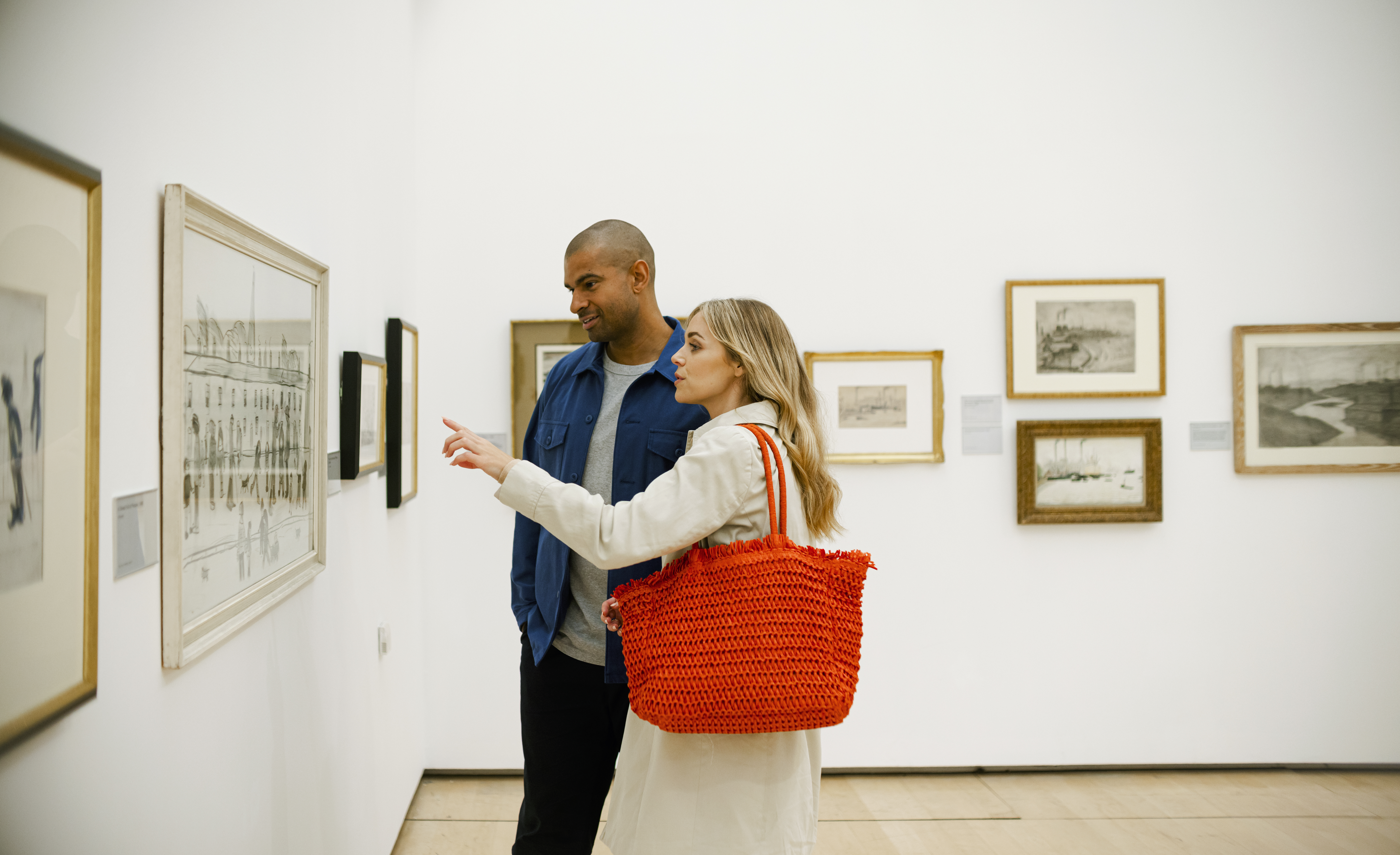A couple looking at art displays in The Lowry, Greater Manchester