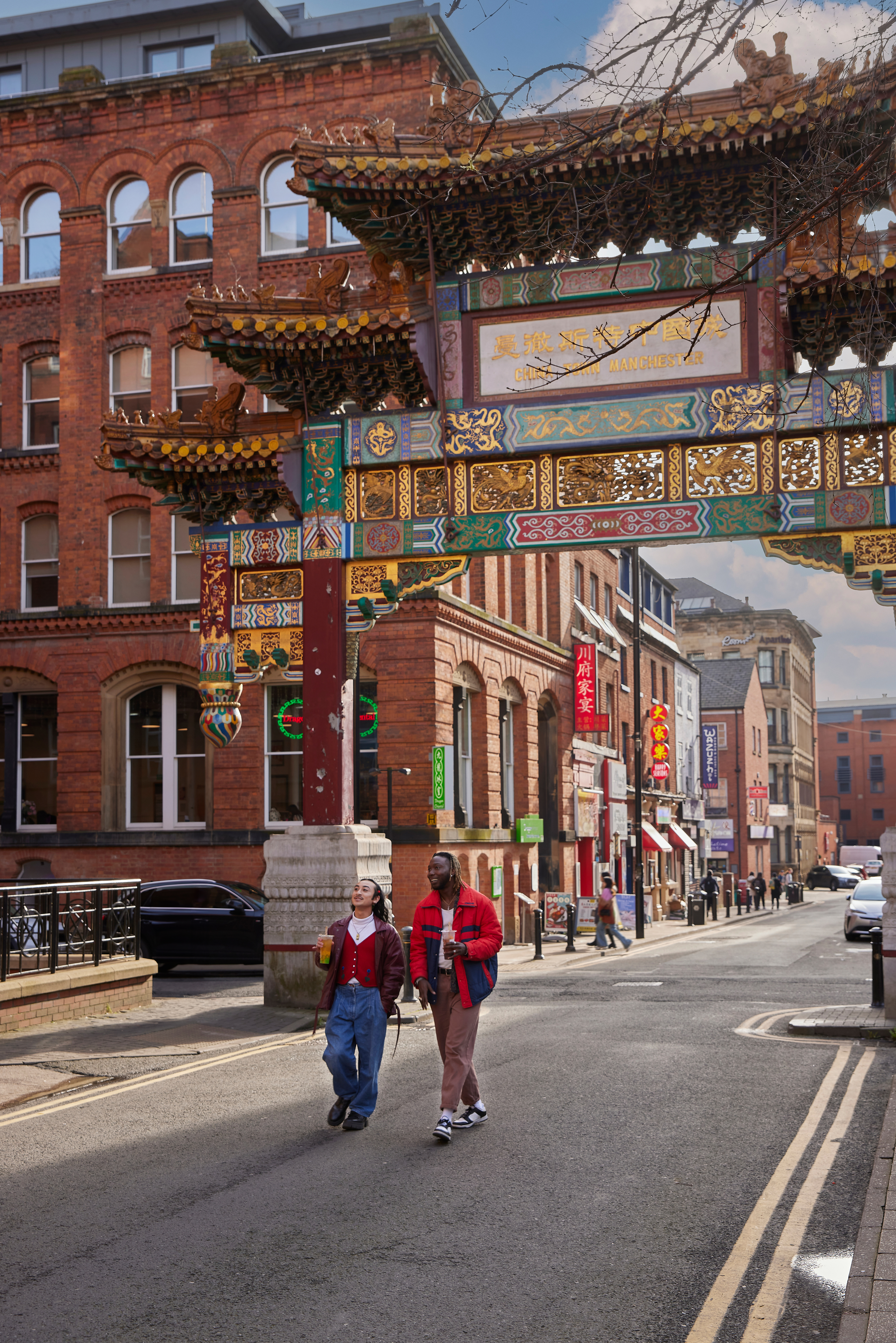 Two people chatting, exploring a local Chinatown district.