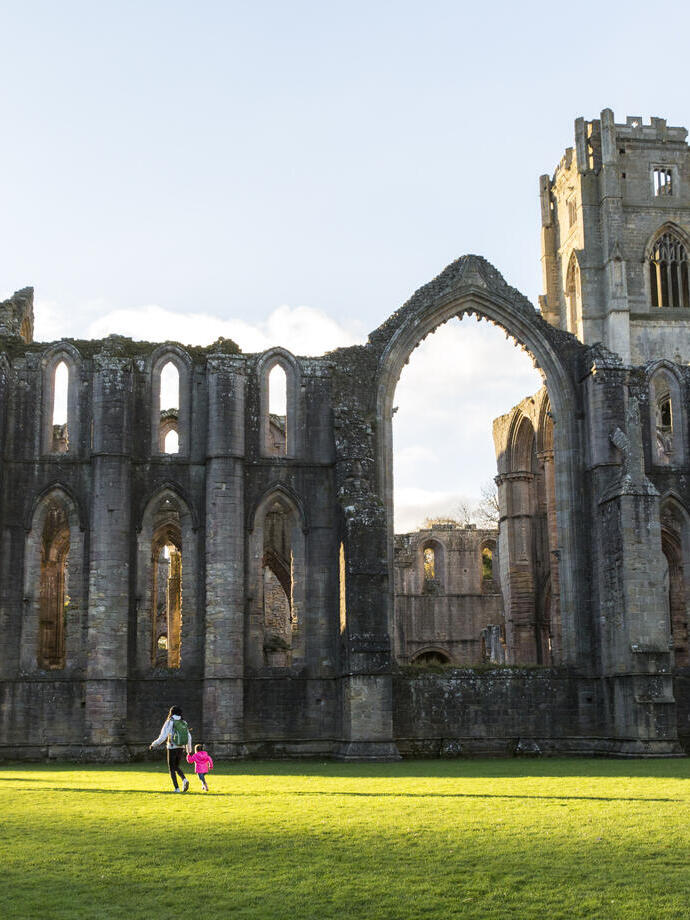 Visitors walking in the garden at Fountains Abbey and Studley Royal Water Garden, North Yorkshire