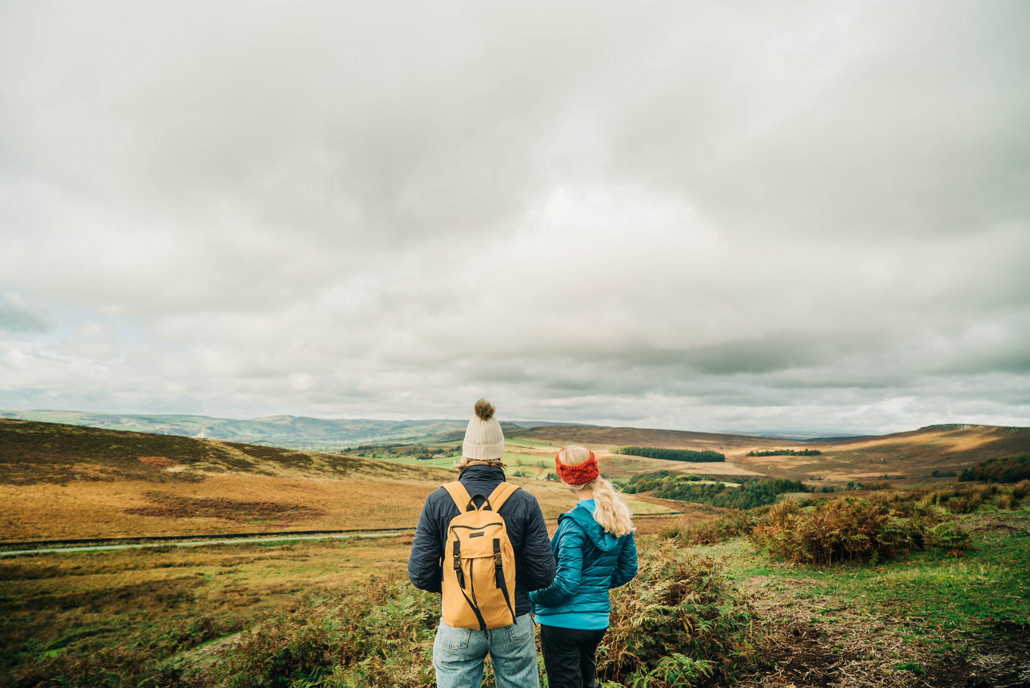 Two girls walking with panoramic views of greenery