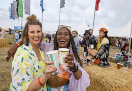 Two women having fun at a festival with friends