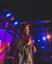 A performer on stage at Brighton's Komedia, a comedy club