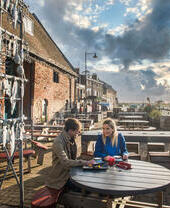 Two people sitting at a table on the Kings Lynn Heritage Trail