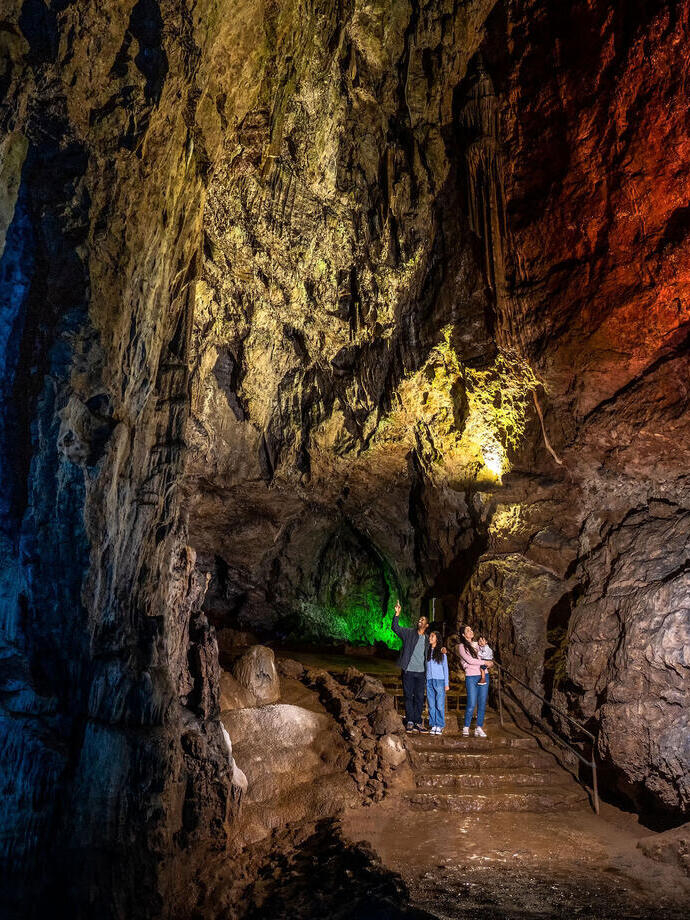 A family standing inside a cave