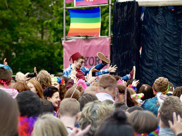 A crowd watching a performance on stage at York Pride