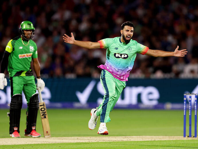 Two cricket players on a pitch.