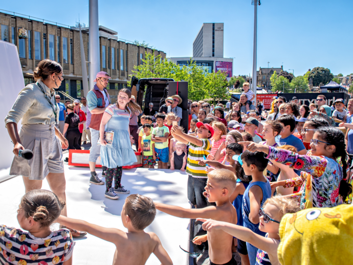 Performers on an outdoor stage at the Bradford Literature Festival