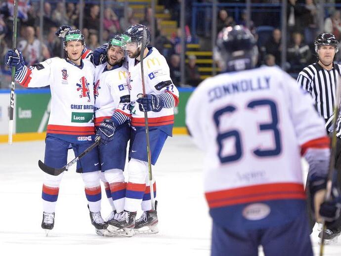 Group of three Great Britain ice hockey players celebrating on the ice together