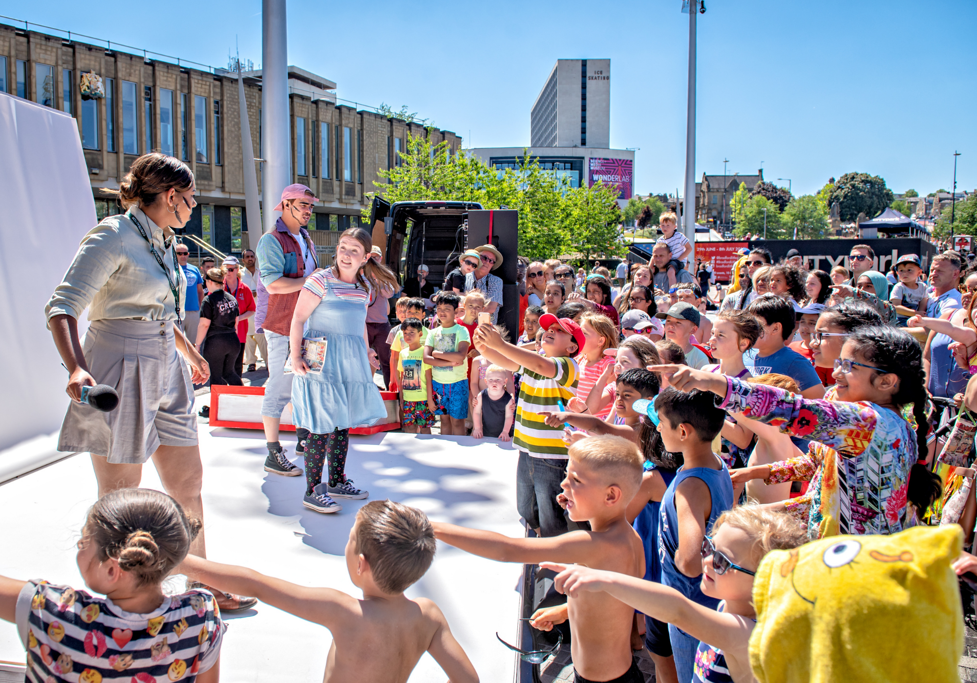 Performers on an outdoor stage at the Bradford Literature Festival