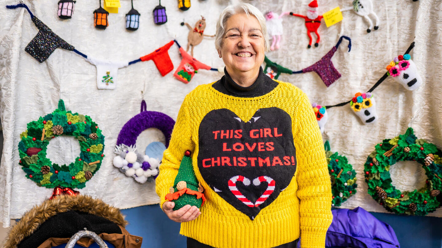 A woman posing in a Christmas jumper for the Norwich Christmas Festive Fair