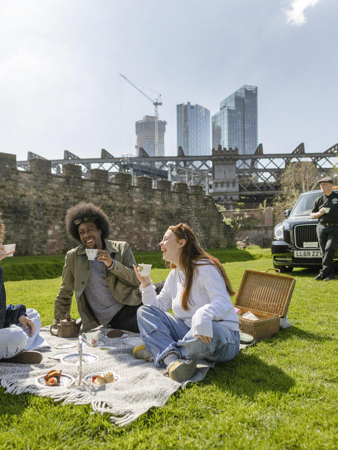 People having a picnic as part of a taxi tour in Manchester