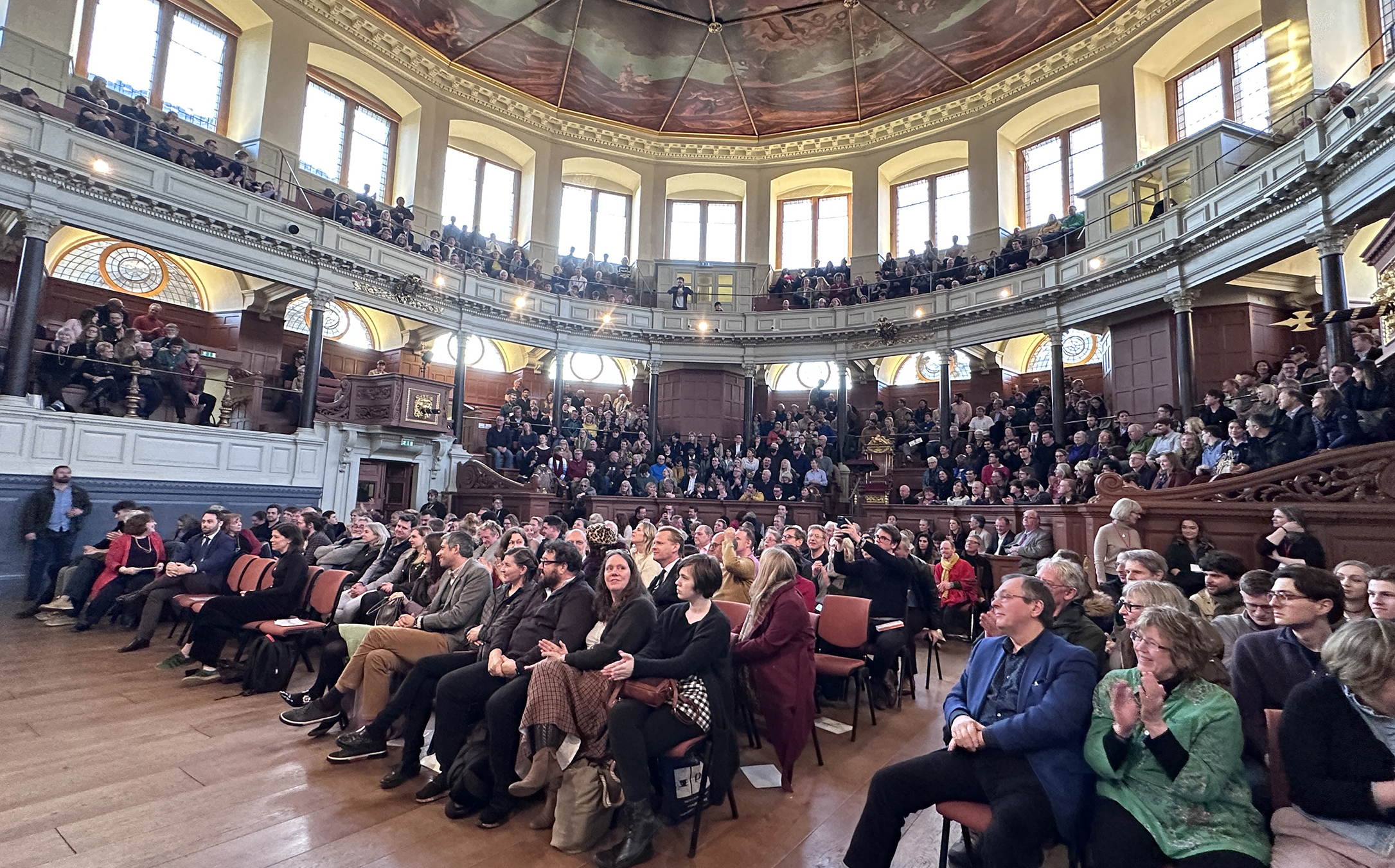 Crowds of people watching a talk on stage at Oxford Literary Festival