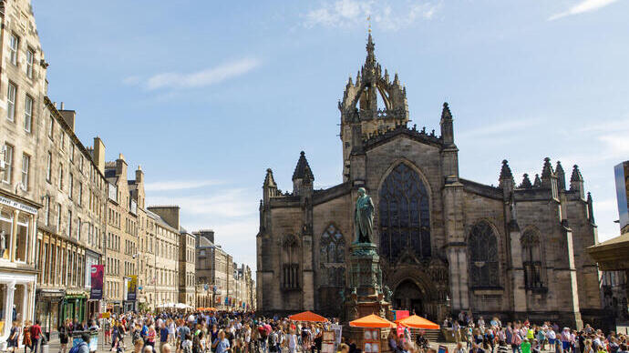 People walking in a city centre on a sunny day