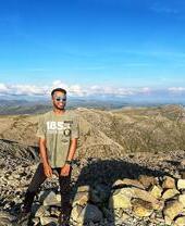 Young man poses on the highest point in England