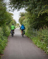 People cycling through the countryside