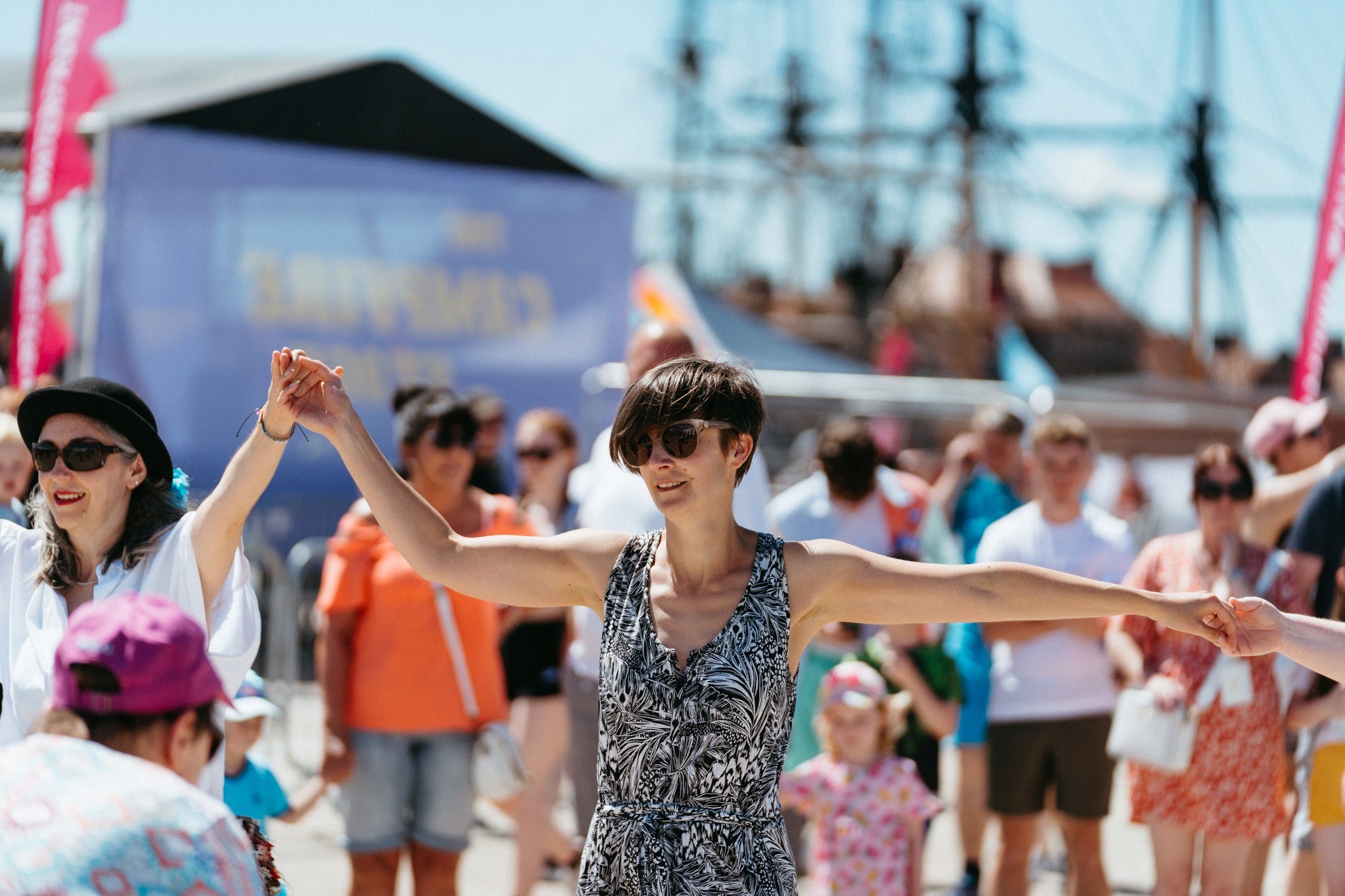 A group of people holding hands at a Tall Ships racing event in Hartlepool