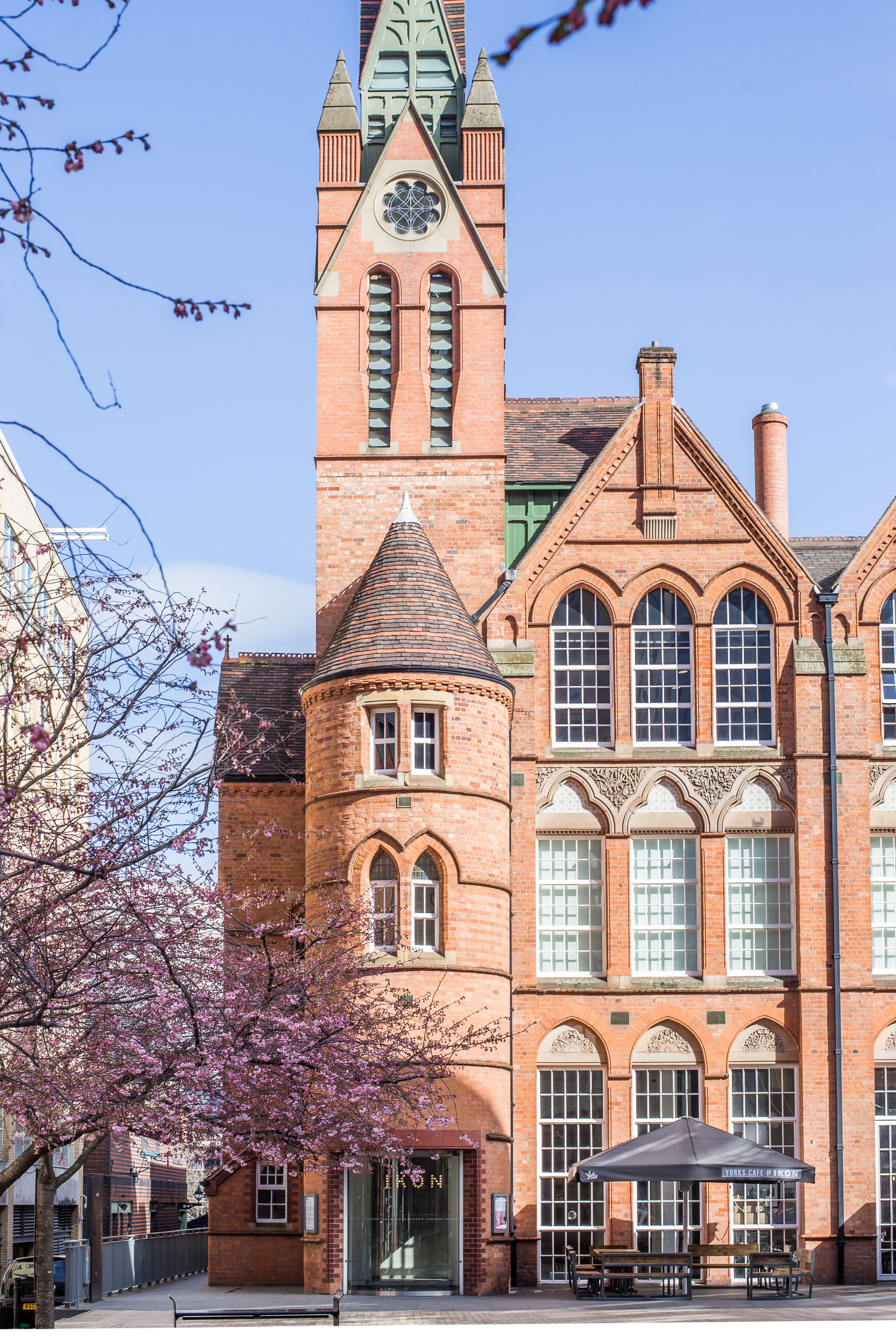 Historic building, trees in bloom on its side