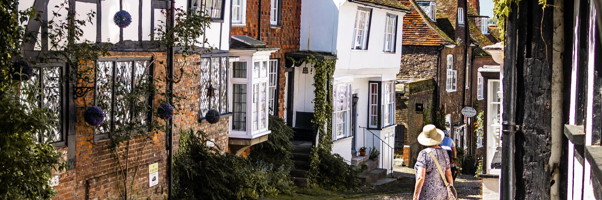 Woman looking down a narrow village street 
