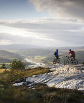 Two people on mountain bikes on the Balblair mountain trail