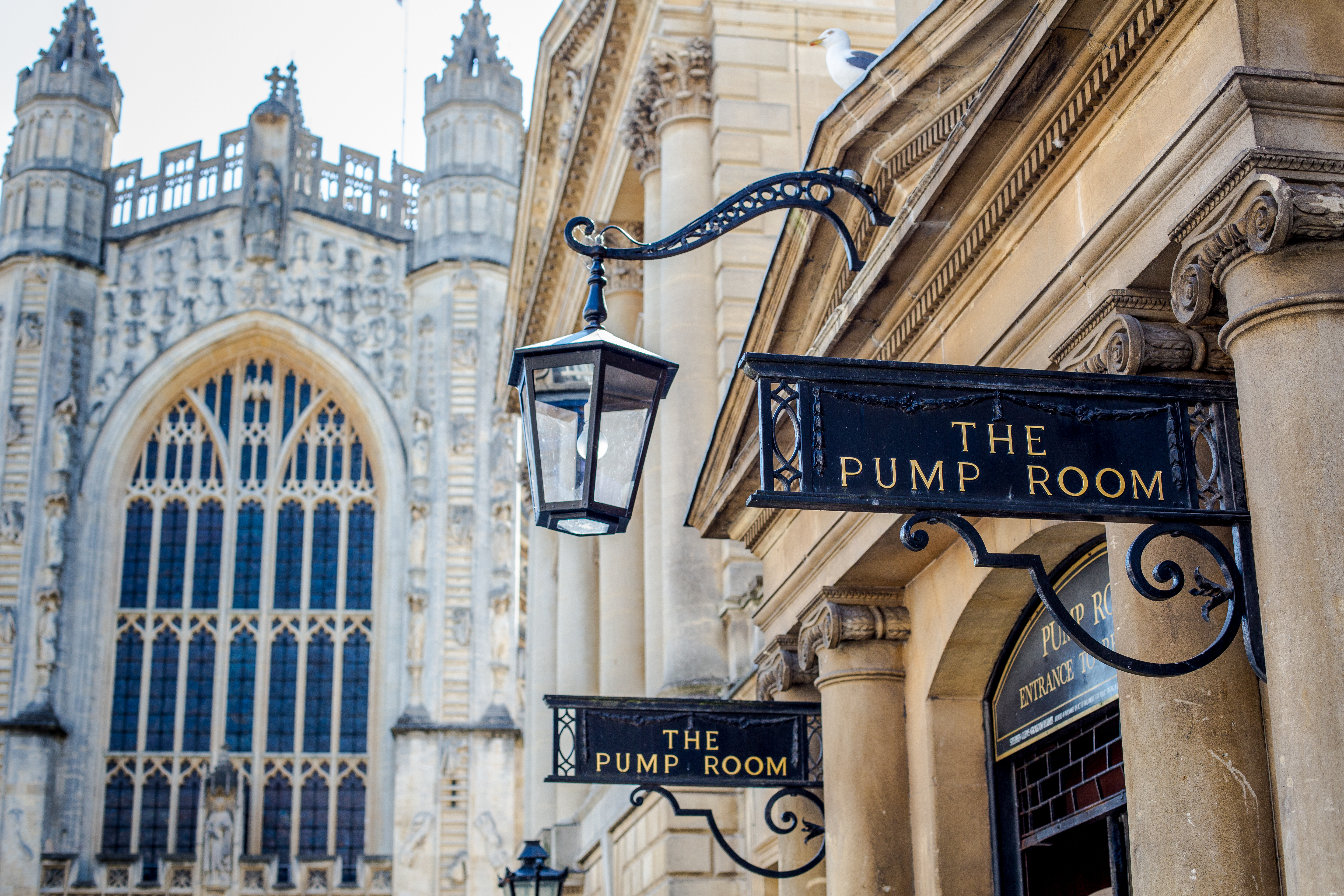 A view of the entrance to The Pump Room with a church in the background at an elegant upmarket restaurant.