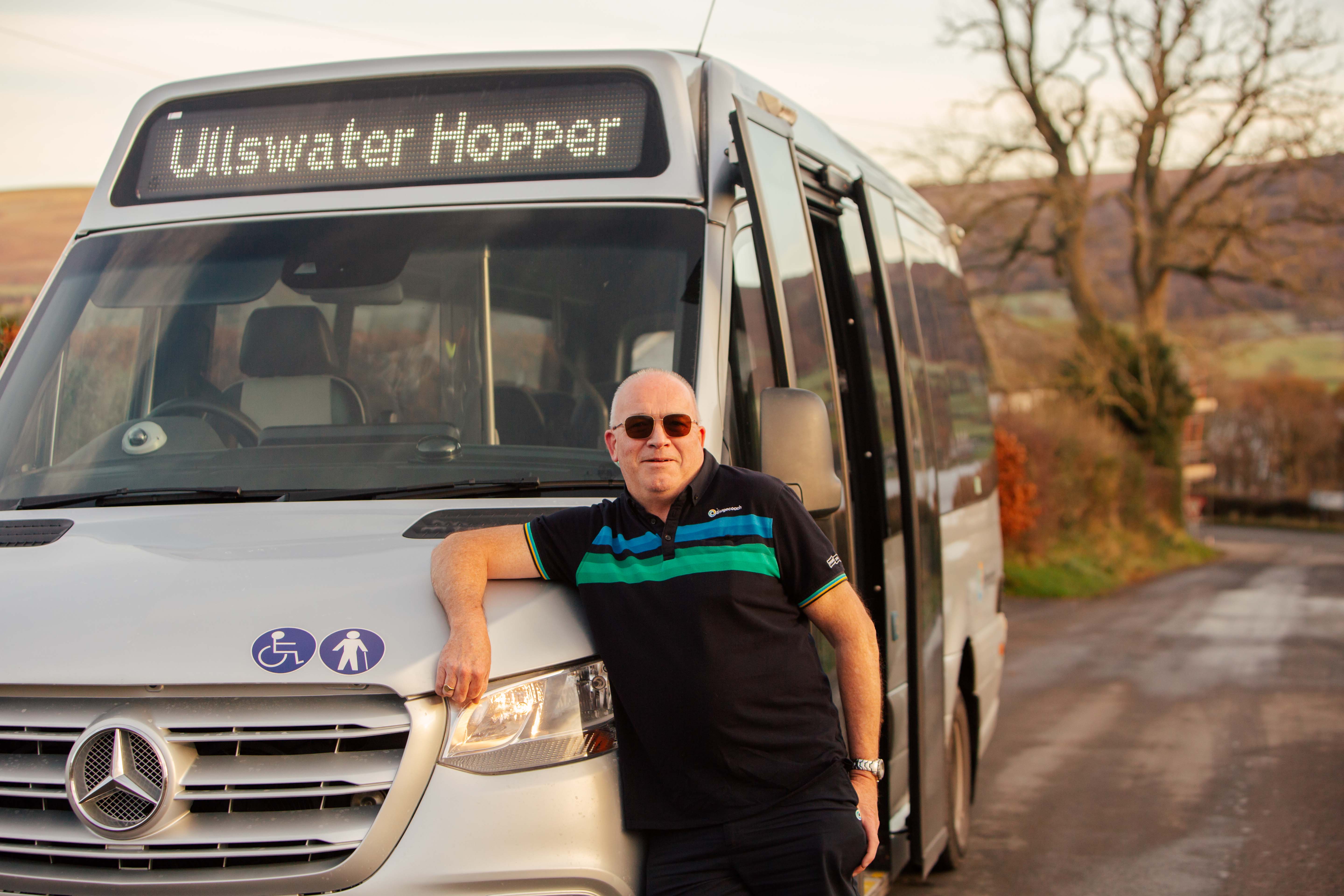 Bus driver standing in front of bus