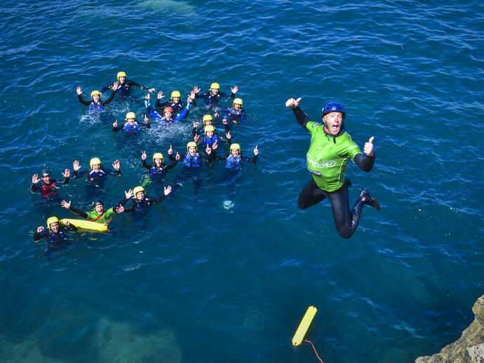 A man diving into the sea off the coast of Cornwall