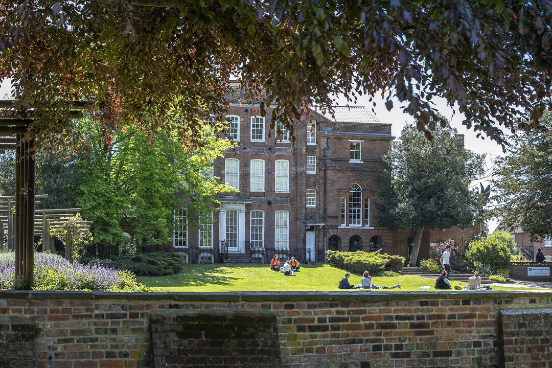 People relaxing in the grounds in from of Hollytrees Museum