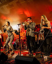 A brass band performing on stage at Unearthed Festival in Wales