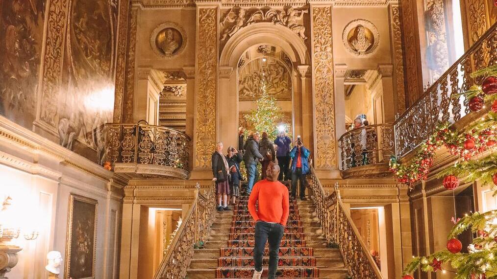 Group of people walking down stairs under a painted ceiling