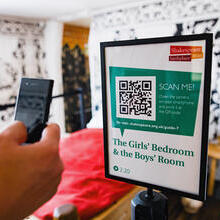 Close up of a hand scanning a QR code with a smart phone at the Shakespeare Birthplace Trust