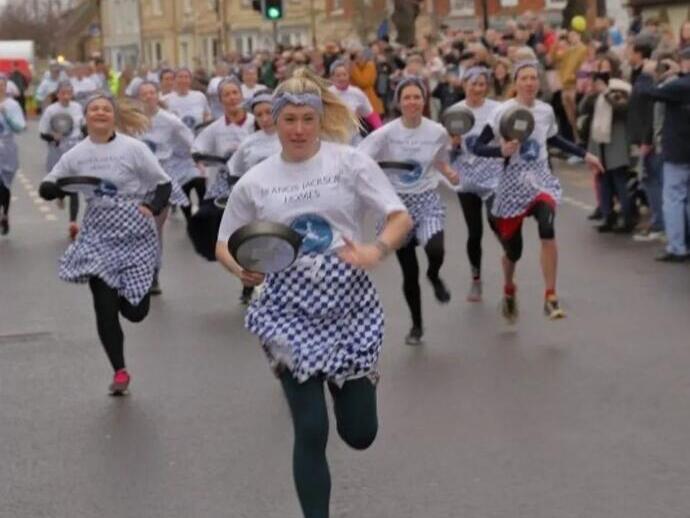 People taking part in the Olney pancake race