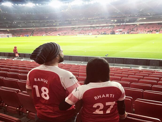 Couple stood in the Emirates Stadium during an Arsenal Stadium Tour