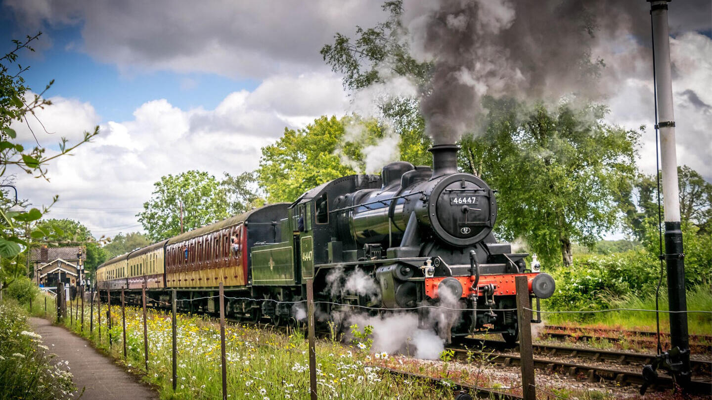A steam train moving down a track