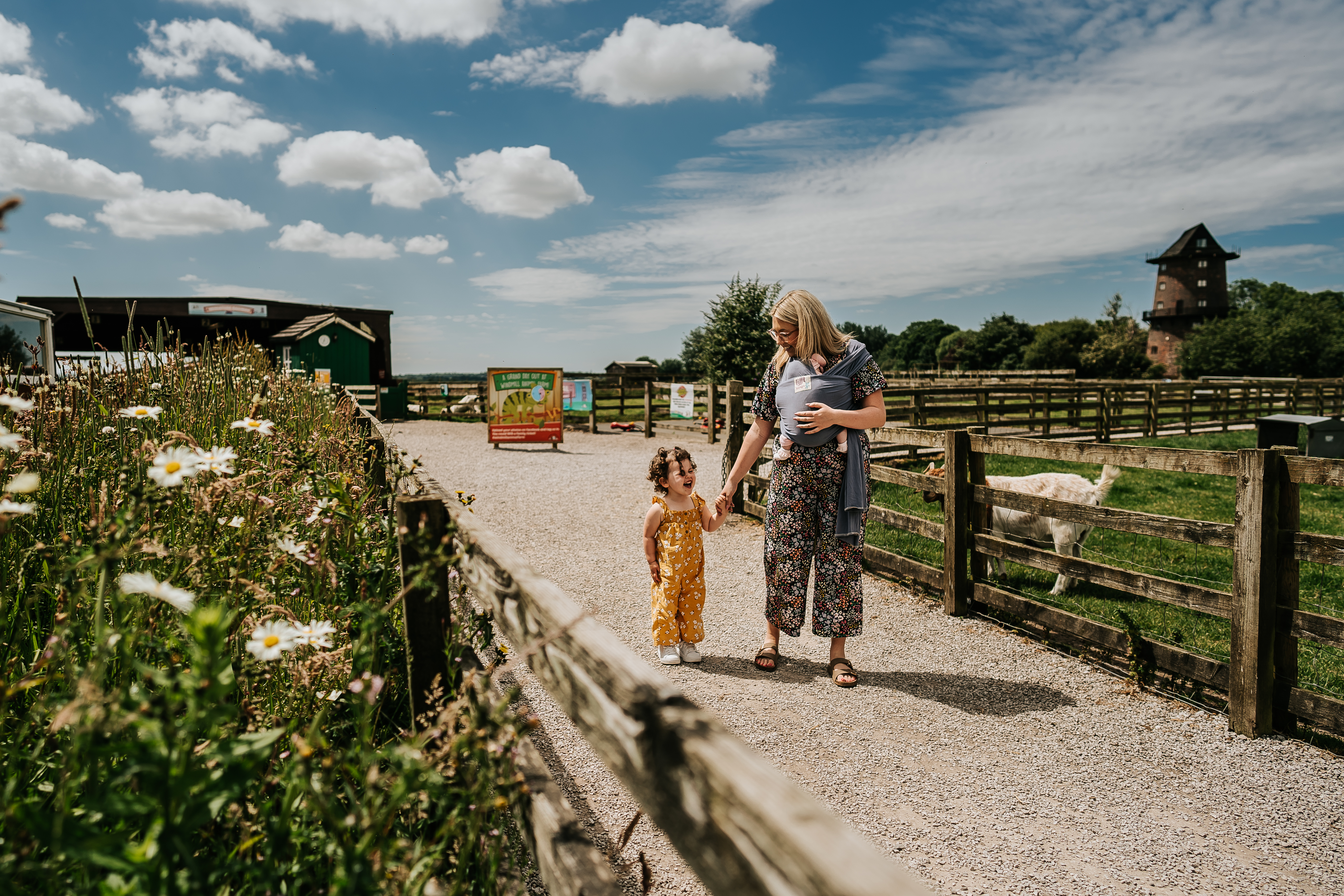 A woman and a child walk through an animal farm attraction