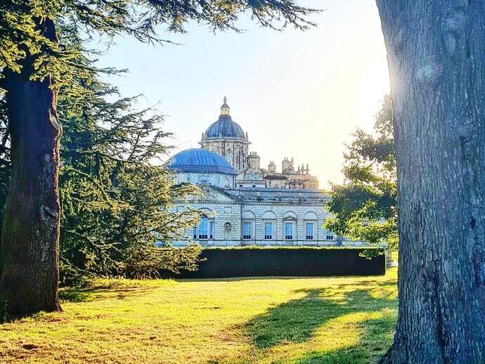 Historic mansion surrounded by trees and garden