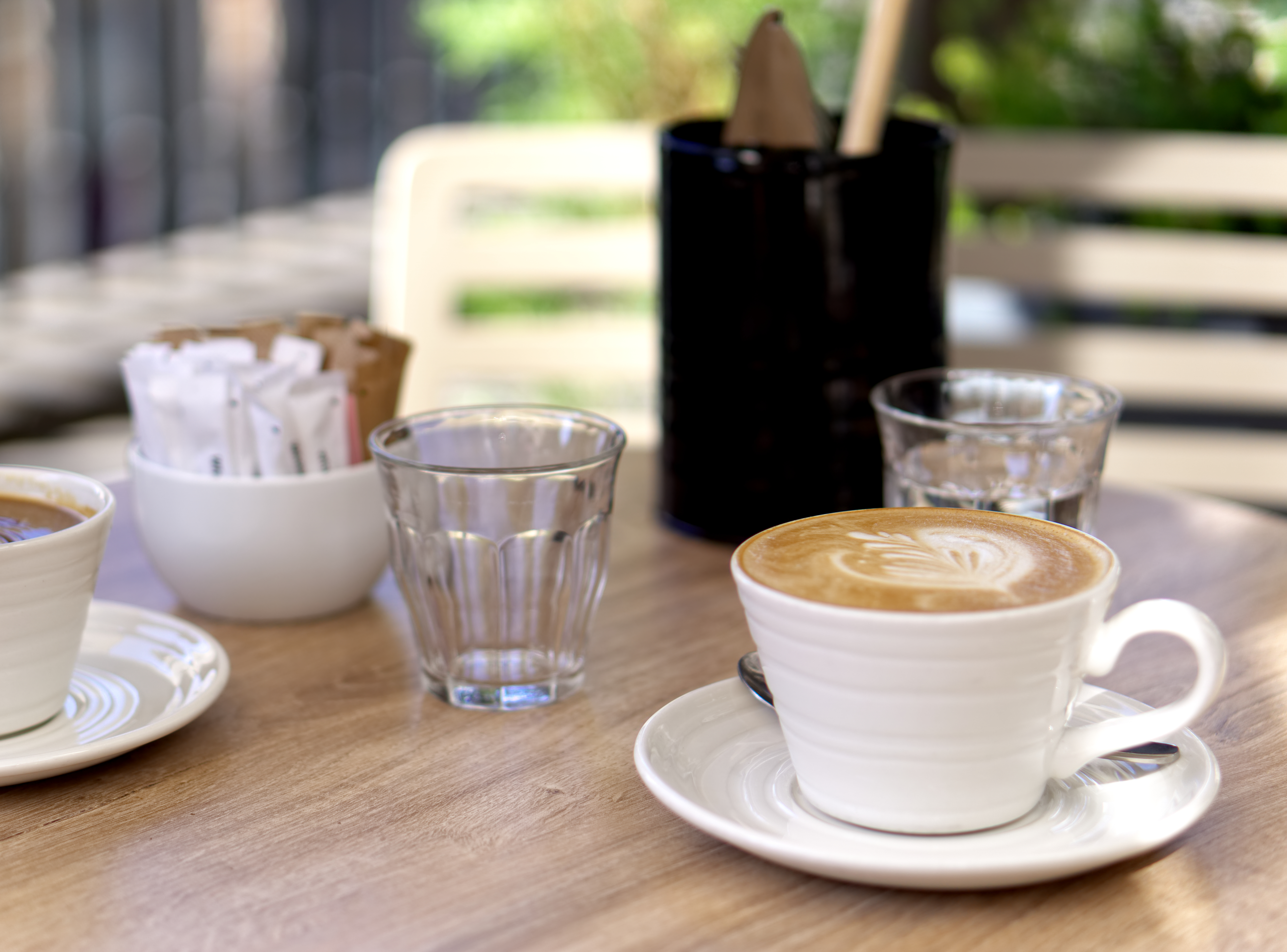 Cup of coffee latte on wooden table in a cafe.