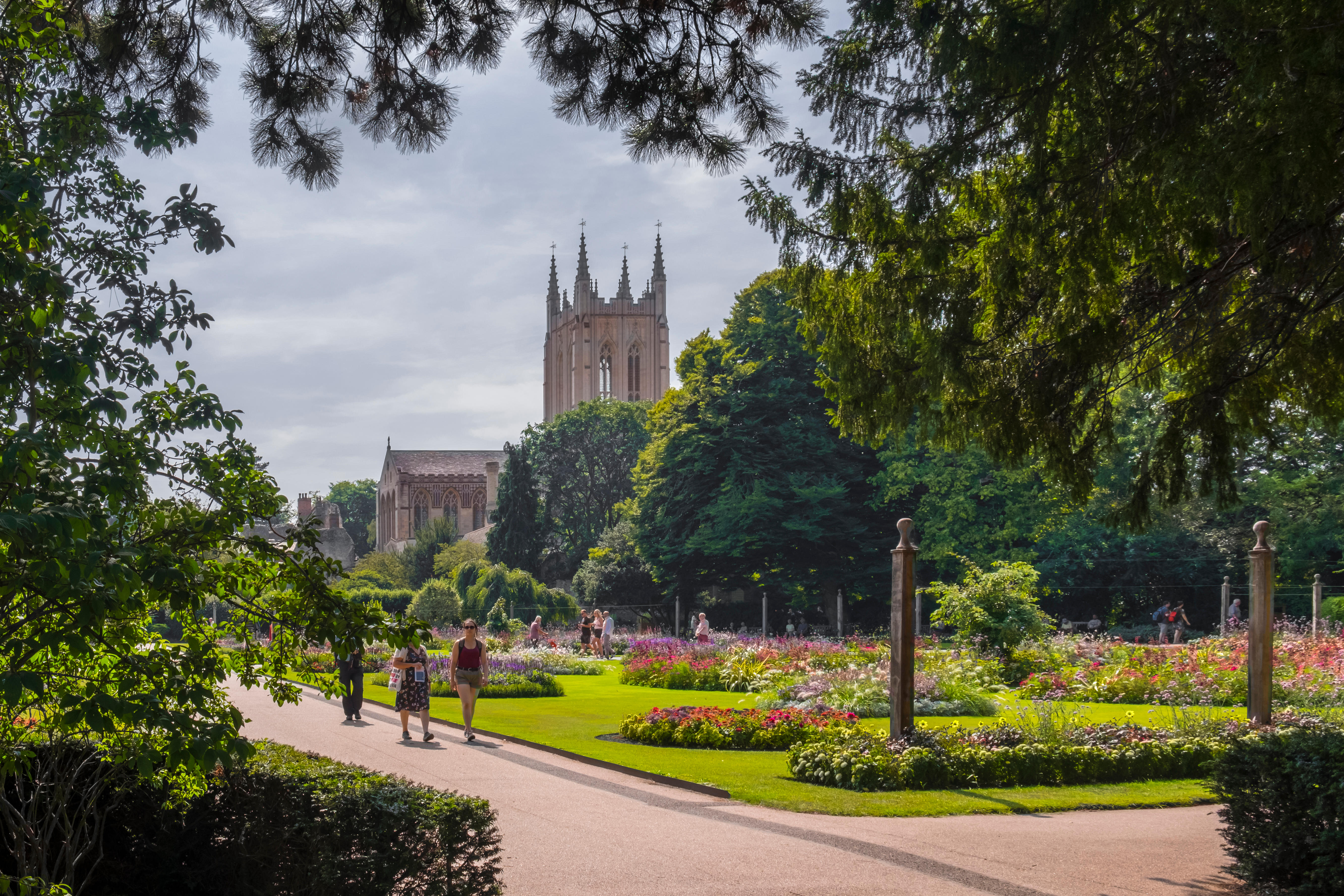 A cathedral amongst manicured gardens on a summer's day