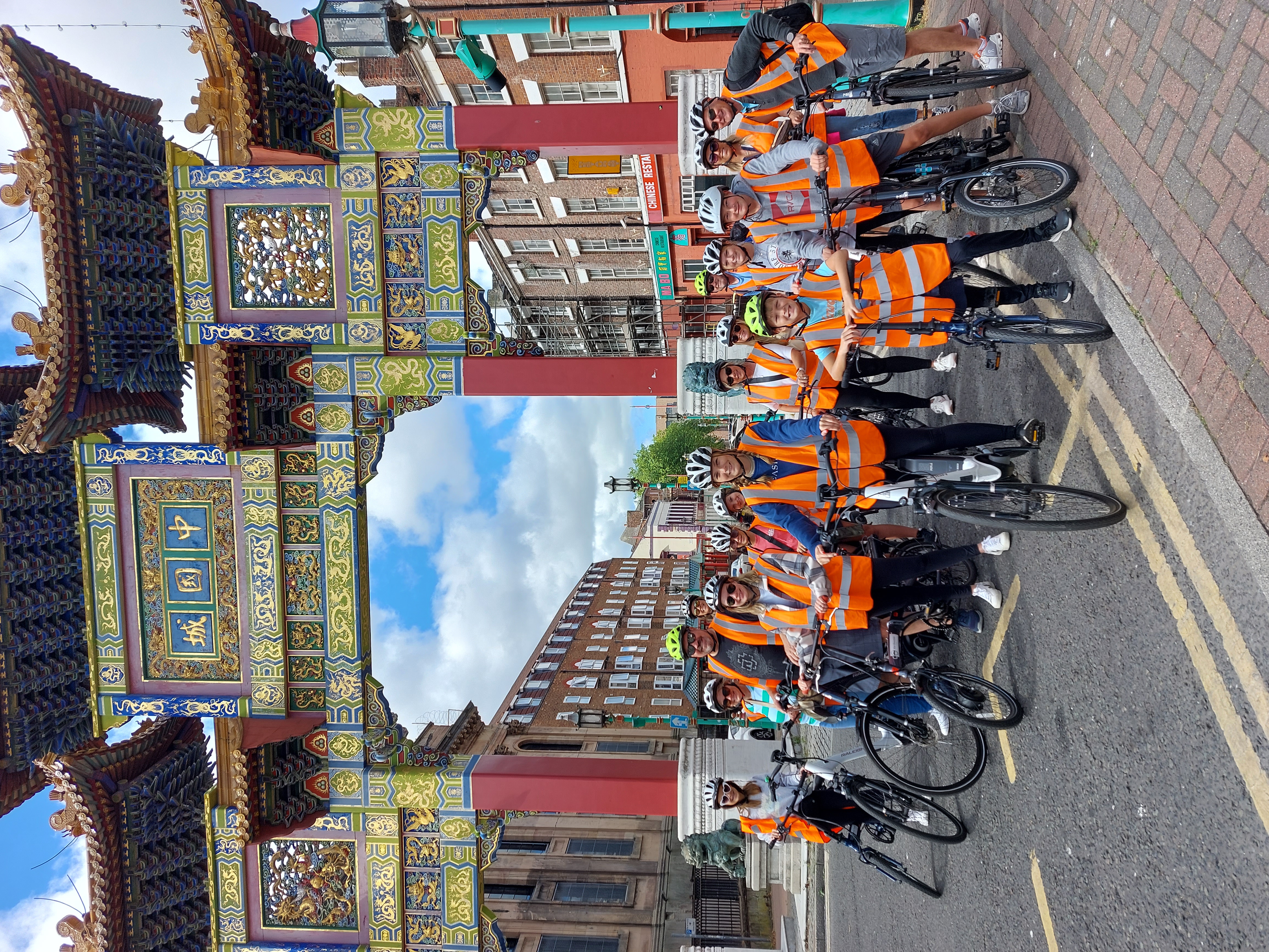 A tour group on bicycles near the Chinese Arch in Liverpool